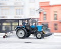 Snow removal machine cleaning the street from snow. Snowplow truck removing snow on the street after blizzard Royalty Free Stock Photo