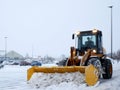 Snow removal machine clearing parking lot during snow storm