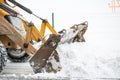Snow removal by tractor in the city Royalty Free Stock Photo