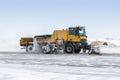 Snow removal truck cleans airport apron in a blizzard