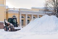 Snow removal vehicle removing snow. Tractor clears the way after heavy snowfall in St. Petersburg, Russia