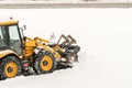 Snow removal. Wheel loader machine or vehicle removing snow from the roads Royalty Free Stock Photo