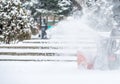 Snow-removal work with a snow blower. Man Removing Snow. heavy precipitation and snow pile Royalty Free Stock Photo