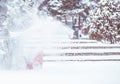 Snow-removal work with a snow blower. Man Removing Snow. heavy precipitation and snow piles. Royalty Free Stock Photo