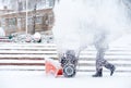 Snow-removal work with a snow blower. Man Removing Snow. heavy precipitation and snow pile Royalty Free Stock Photo