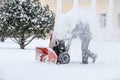 Snow-removal work with a snow blower. Man Removing Snow. heavy precipitation and snow pile Royalty Free Stock Photo