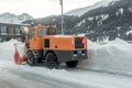 Snow remover truck cleaning snow covered streets during winter