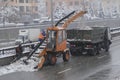 Tractor cleaning the road from the snow. Excavator cleans the streets of large amounts of snow in city