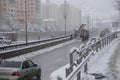 Snow removing equipement on the street in blizzard. Trucks with snowplow on winter city streets.