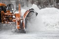 Snow-removing machine cleans the street