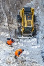 Snow-removing machine and workers clean the road Royalty Free Stock Photo