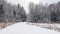 Snow road in the forest between the trees. Russian winter Royalty Free Stock Photo