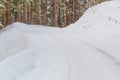 Ice and snowstorm on a country road. Clearing the road from snowdrifts