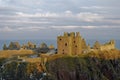 Snow seen on the cliffs on which Dunnottar Castle lies, lit up in the Golden Evening Sun of a cold Winters day Royalty Free Stock Photo