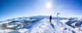 Snow shoe hiker a the summit of the snowy mountain. panoramic picture of winter hiker at the top of the hill. gorgeous swiss alps Royalty Free Stock Photo