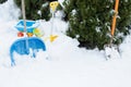 Snow shovel and kids toy car in a snow bank. Winter shoveling. Removing snow after blizzard.