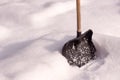 Snow shovel stands in the snow. winter frosty day after snowfall