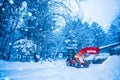 snow shovel tractor on a heavy snowy day at Heike No Sato Village in Tochigi Prefecture, Nikko City, JAPAN. soft focus