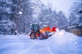 snow shovel tractor on a heavy snowy day at Heike No Sato Village in Tochigi Prefecture, Nikko City, JAPAN. soft focus