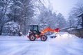 snow shovel tractor on a heavy snowy day at Heike No Sato Village in Tochigi Prefecture, Nikko City, JAPAN. soft focus