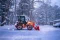 snow shovel tractor on a heavy snowy day at Heike No Sato Village in Tochigi Prefecture, Nikko City, JAPAN. soft focus