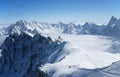 Snow slope with mountain-skiers, the Alps Royalty Free Stock Photo