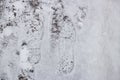 Snow and slush footprints on the road Royalty Free Stock Photo