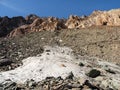 Snow and stone meadow, minerals scattered on the field. Minimalist scenic autumn landscape with mossy stones in sunlight in