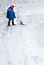 snow storm in the city. Roads and sidewalks covered with snow. Worker shovel clears snow. Bad winter weather. Street cleaning Royalty Free Stock Photo