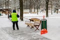 snow storm in the city. Roads and sidewalks covered with snow. Worker shovel clears snow. Bad winter weather. Street cleaning