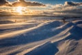 Snow storm, snowdrift and snow dust at sunset on the road, dramatic landscape of windy winter weather