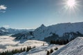 Snow and sun on the top of the mountains and fog down the valley Royalty Free Stock Photo