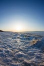 Snow sunrise wave on the shore of Olkhon. Baikal