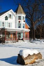 Snow surrounds a Victorian home decorated for Christmas
