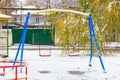 Snow on the swings. Winter background, selective focus