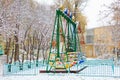 Snow on the swings. Winter background, selective focus