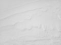 Snow texture. The wind in the tundra and in the mountains sculpts patterns and ridges on the snow surface. Winter Royalty Free Stock Photo
