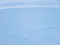 Snow texture. The wind in the tundra and in the mountains sculpts patterns and ridges on the snow surface. Winter Royalty Free Stock Photo