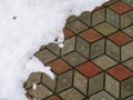 Snow on tile background. Closeup photograph of melting snow on a pavement made of gray concrete tiles Royalty Free Stock Photo