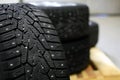 Snow tires with metal studs in garage