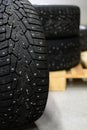 Snow tires with metal studs in garage