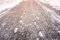 Snow traces of two people on an asphalt path in the city. Abstract silhouette of a person`s tracks on a road in winter Royalty Free Stock Photo