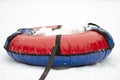 Snow tubing in the snow on a white background. Winter, recreation, sports - winter activities concept