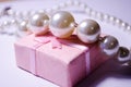 Luxurious pearl jewelry on a pink box. Snow-white pearls. Bijouterie. Jewelry. Snow-white beads on a white background. Brilliant p Royalty Free Stock Photo