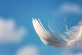 Snow-white feather on blue sky background with clouds, lightness concept Royalty Free Stock Photo