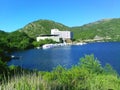 A snow-white hotel at the foot of a mountain on the shore of Lake Potrero