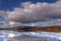 Snow white peaks enfold by lovely cloud scape and reflections Royalty Free Stock Photo