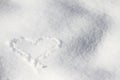 Snow. White snow. Heart on the white snow. Winter background.
