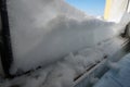 snow on the windowsill against the blue sky