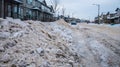 Snow windrow pilled up on the roadside in the Edmonton suburbs